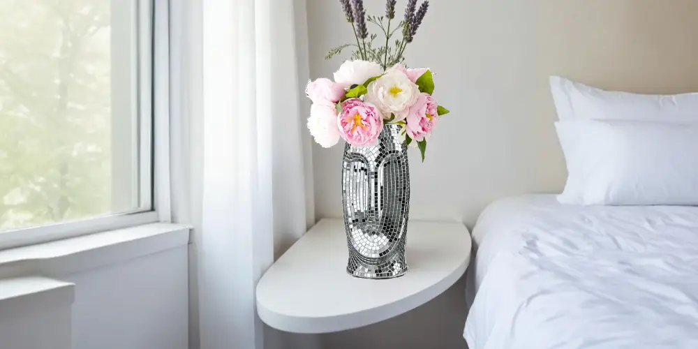 Removing stains from a narrow-necked glass vase with vinegar and baking soda for a spotless finish.
